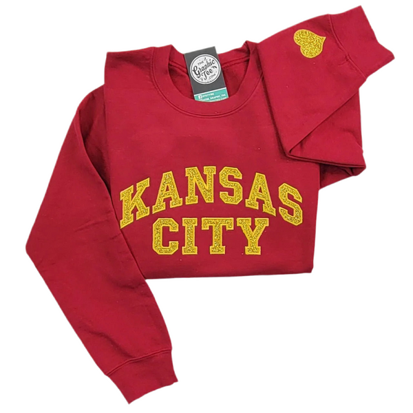 Sudadera de cuello redondo en rojo oscuro con apliques de purpurina dorada de Kansas City