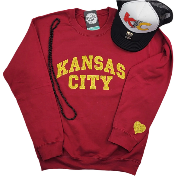 Sudadera de cuello redondo en rojo oscuro con apliques de purpurina dorada de Kansas City